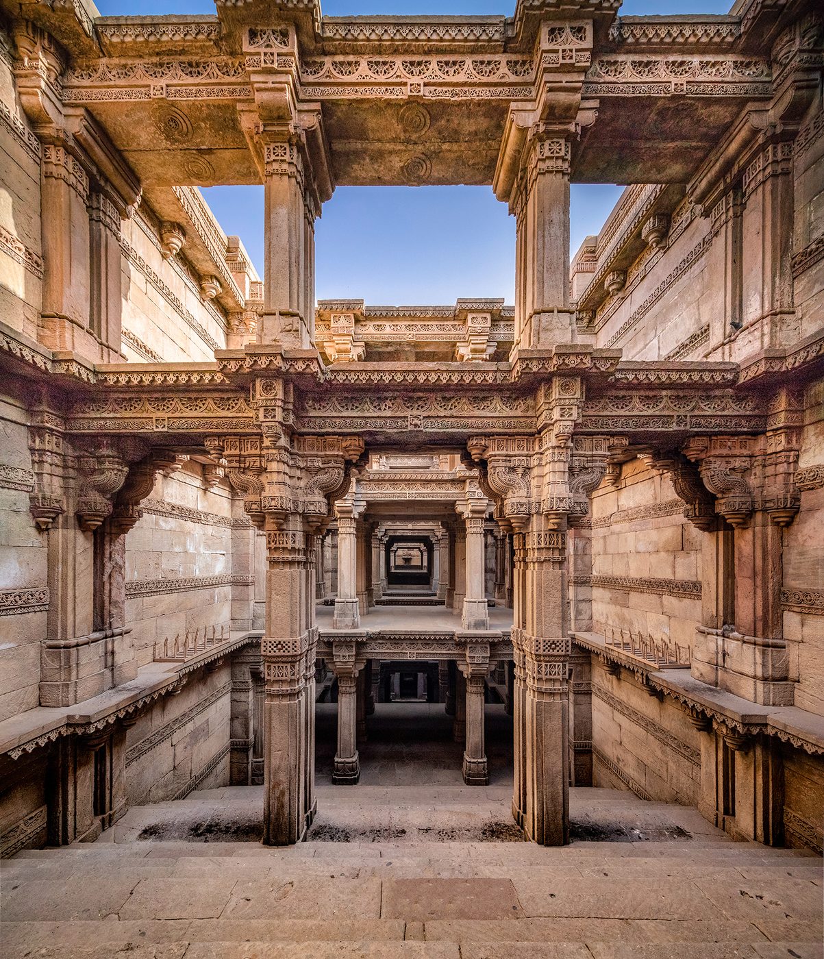 Cool carved stone and descending galleries of a historic stepwell