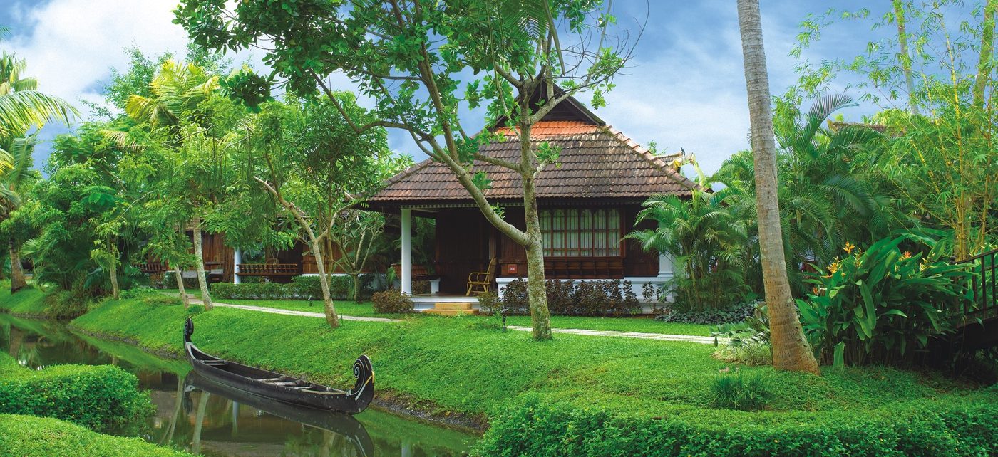 A backwater house on the Kerala lakes, framed by palms and still water