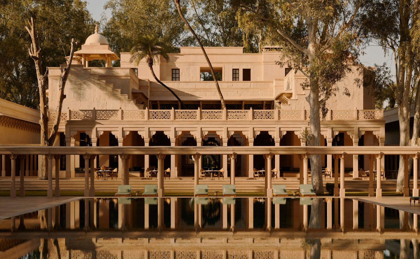 Colonnaded heritage palace and still reflecting water at dusk